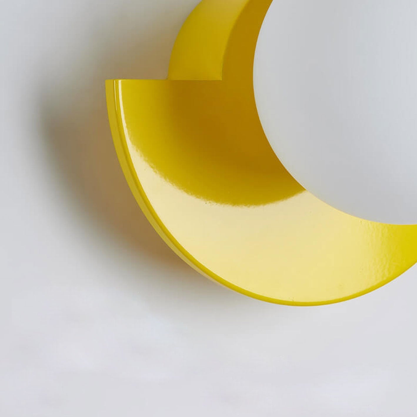Minimalist wall sconce with spherical glass shade, white finish