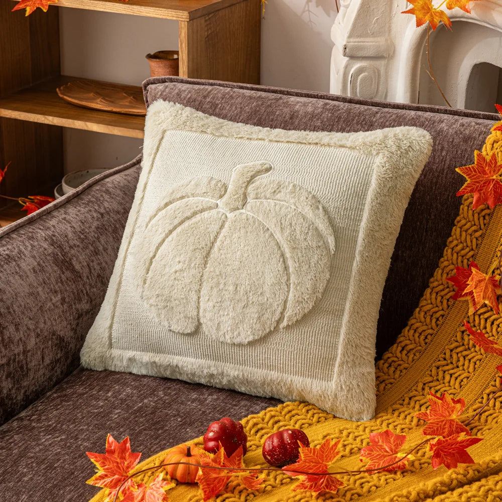 Cream pumpkin pillow cover on a gray sofa with a mustard throw