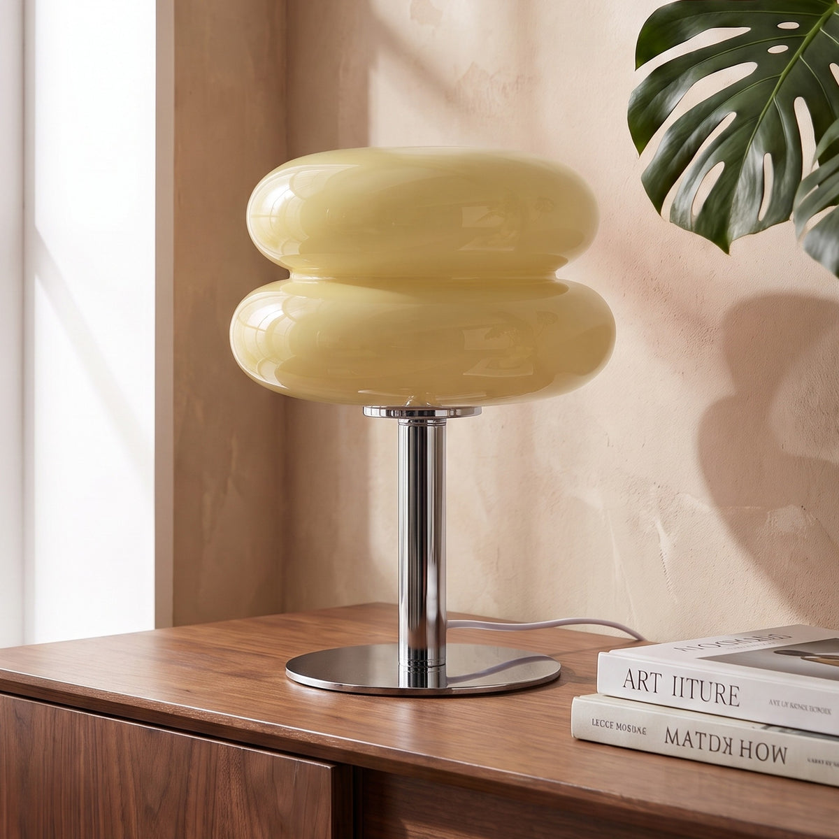 Annika glass table lamp in beige on a walnut sideboard
