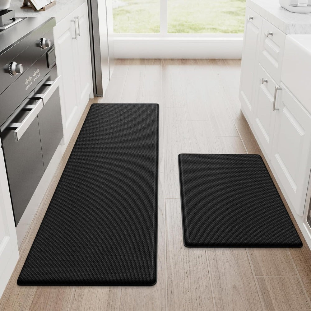 Two black anti fatigue mats in a kitchen