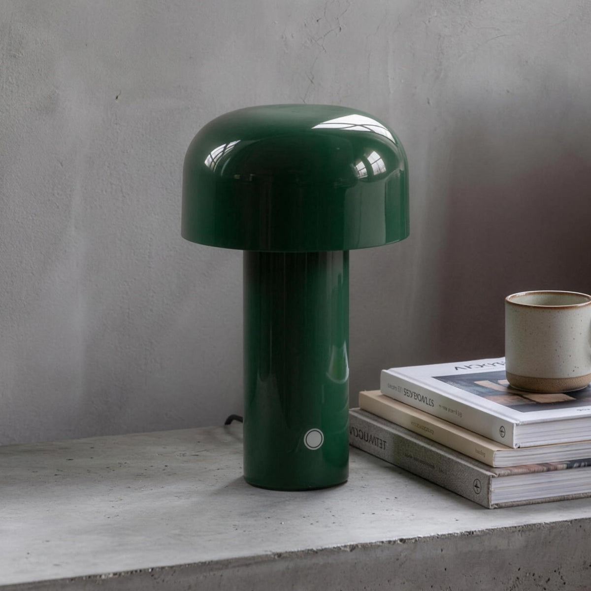 Britta dome table lamp in dark green on a concrete nightstand