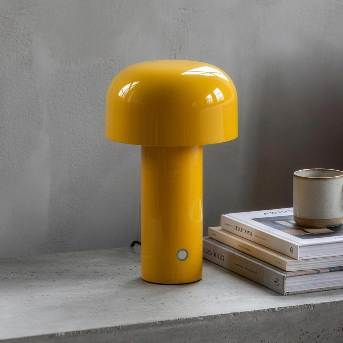 Britta dome table lamp in yellow on a concrete nightstand