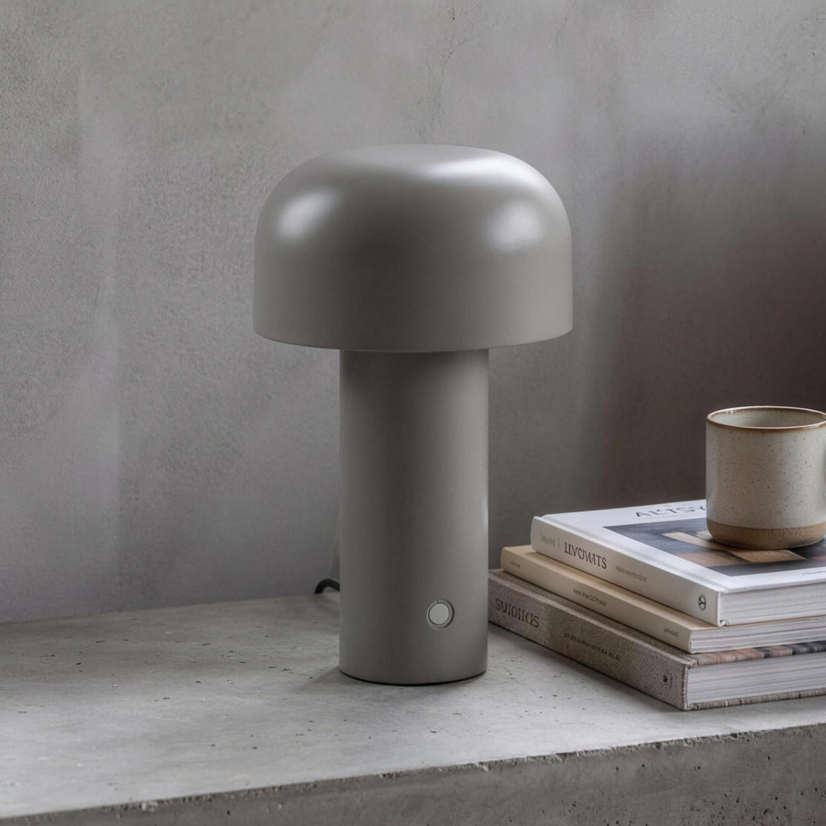 Britta dome table lamp in gray on a concrete nightstand