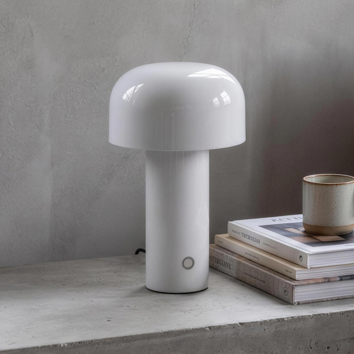 Britta dome table lamp in white on a concrete nightstand