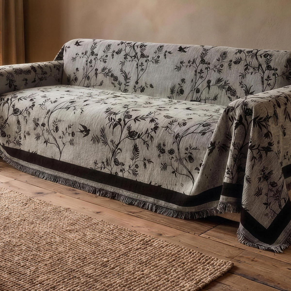 Chenille sofa cover in Light Gray with a black floral jacquard on a sofa