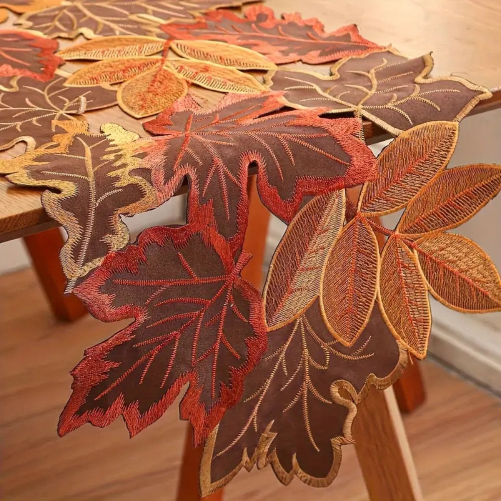 Close view of the embroidered maple and oak leaves on the runner