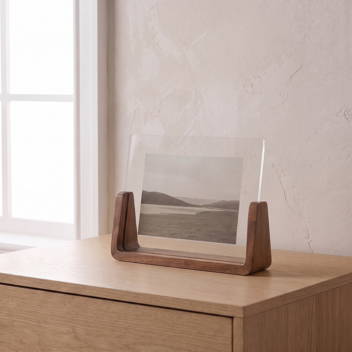 Fana frame, horizontal, walnut wood, holding a landscape print on an oak dresser