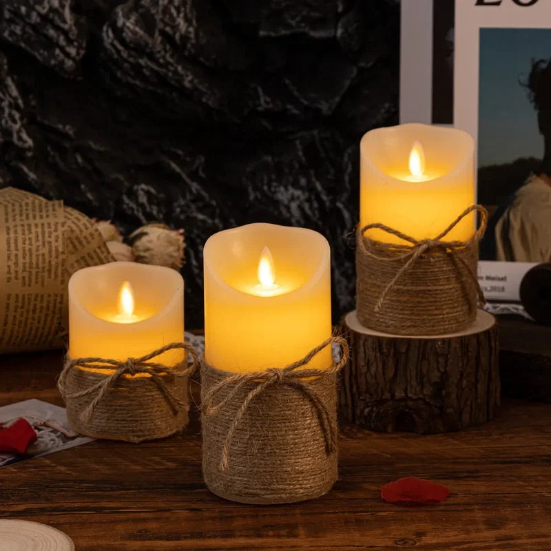 Rope wrapped flameless candles lit on a wood table