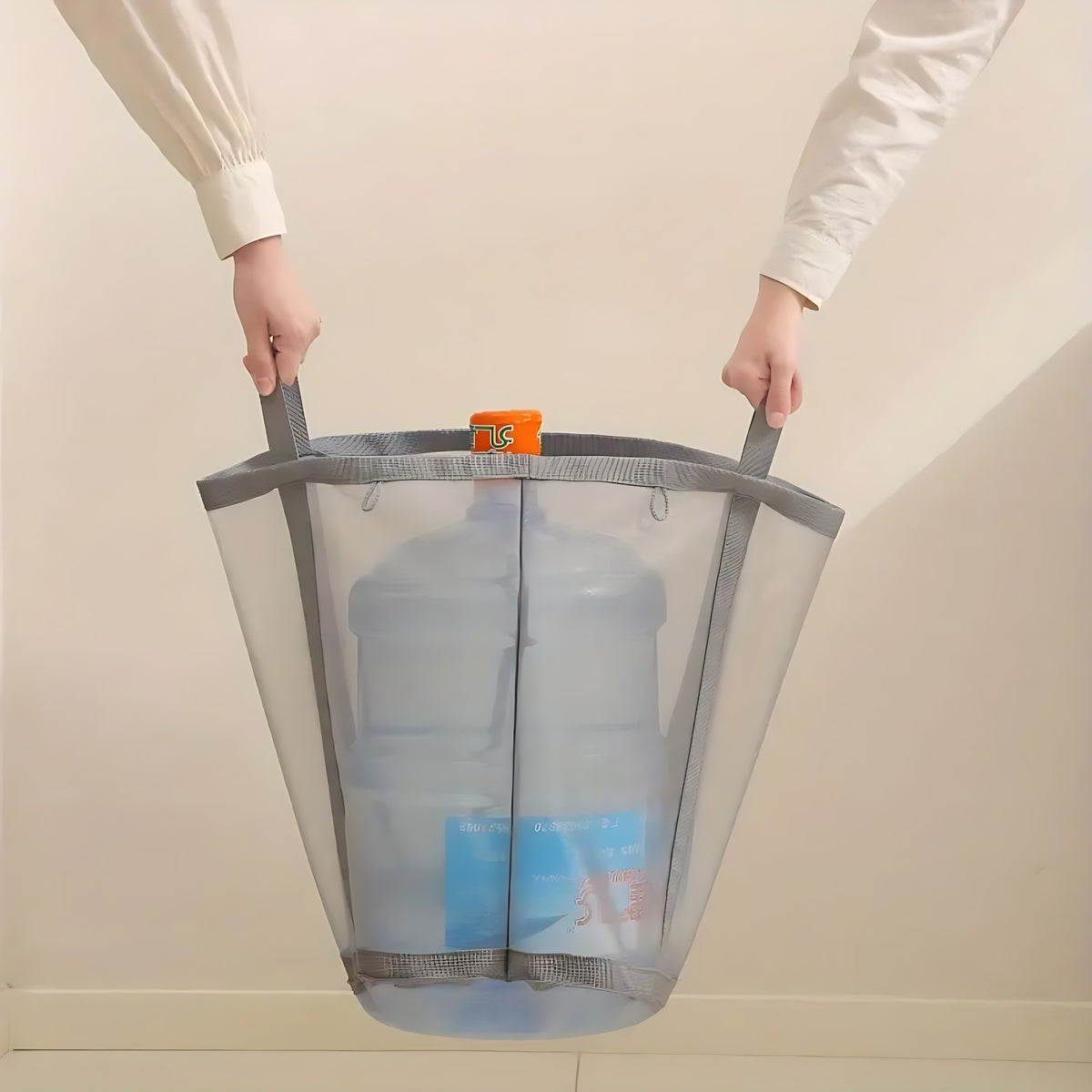 Mesh laundry basket carried by its two handles