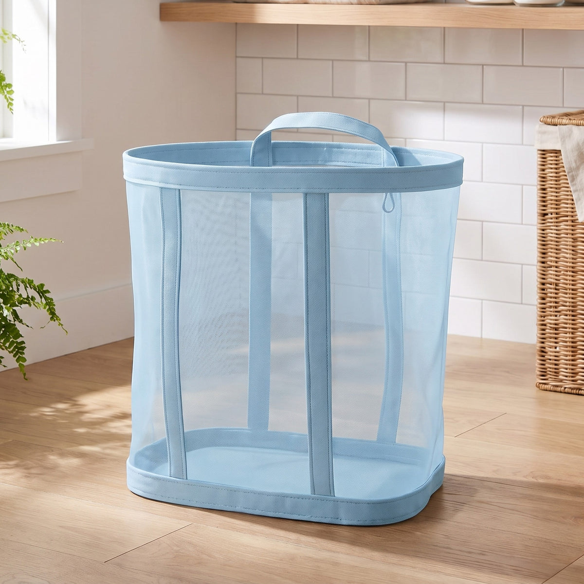 Blue mesh laundry basket standing on a wood floor in a laundry room