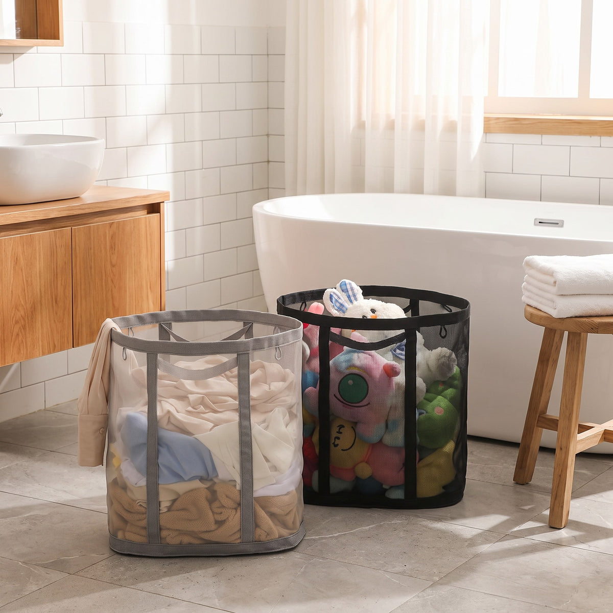 Gray and black mesh laundry baskets filled with laundry and toys in a bathroom