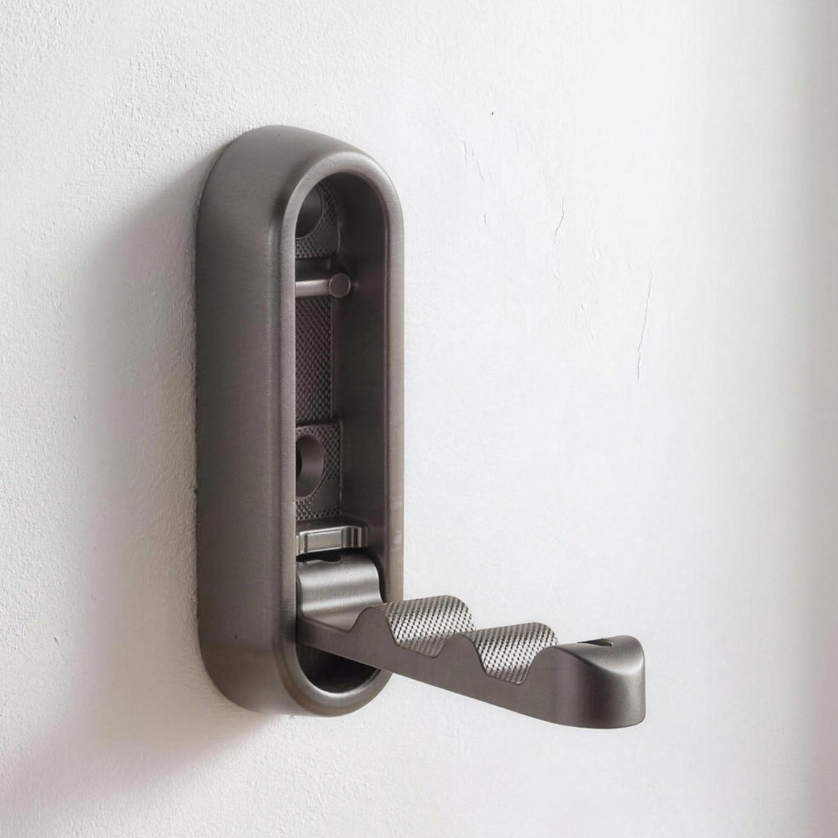 Folding wall hook in Gray opened out on a white wall