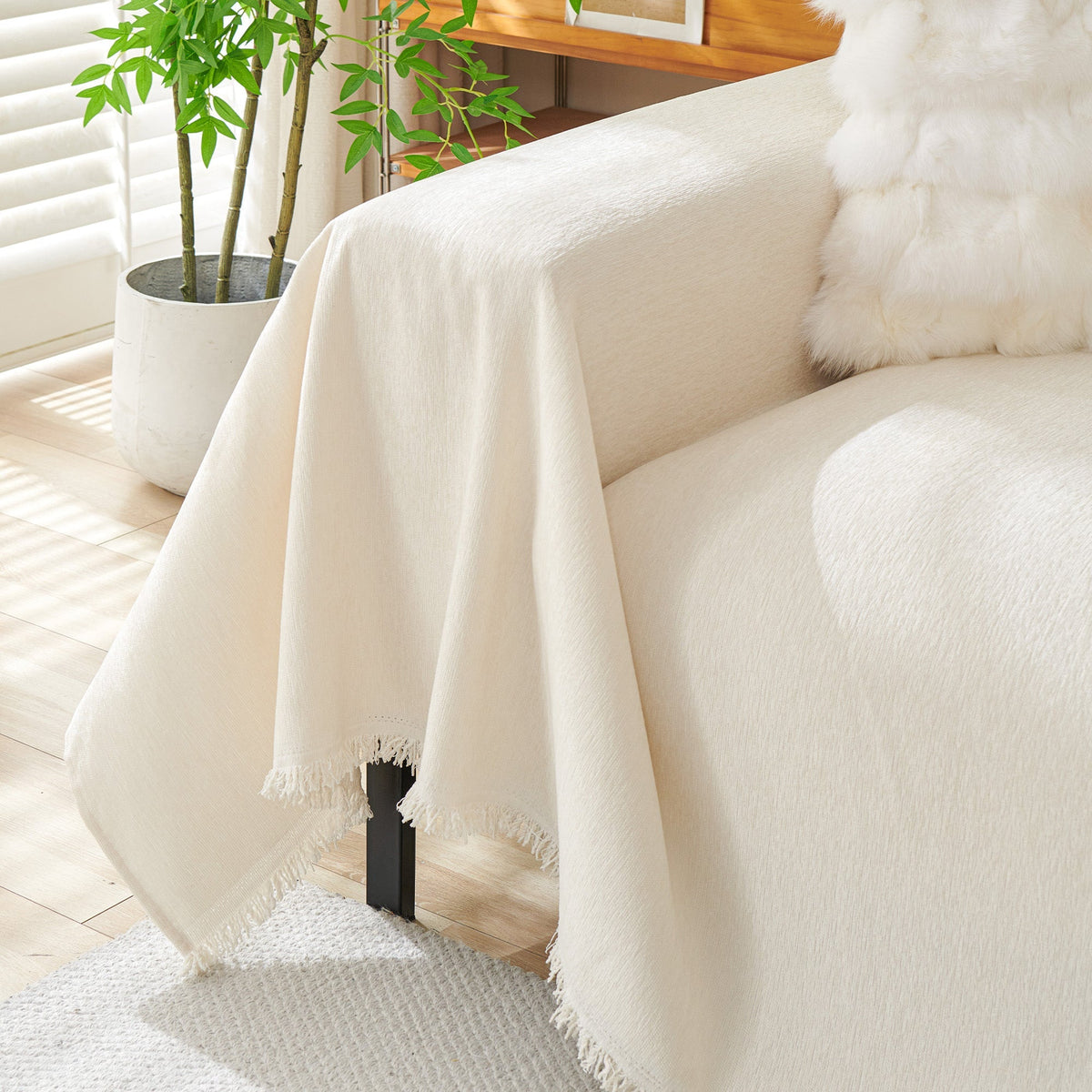 Cream woven cover falling over a sofa arm