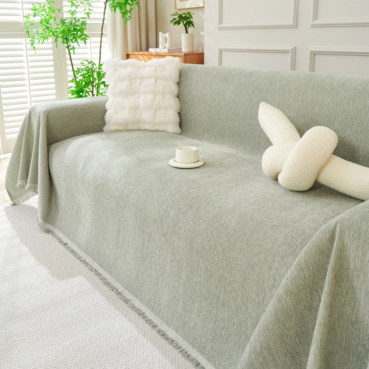 Sage green woven cover with a knot pillow