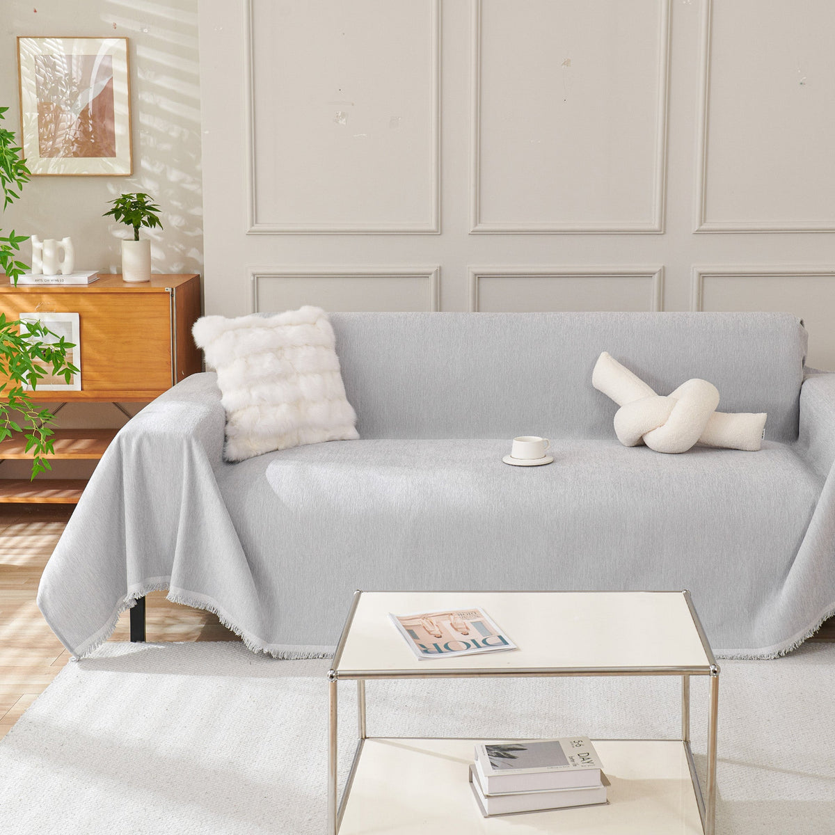 Light gray woven sofa cover over a sofa