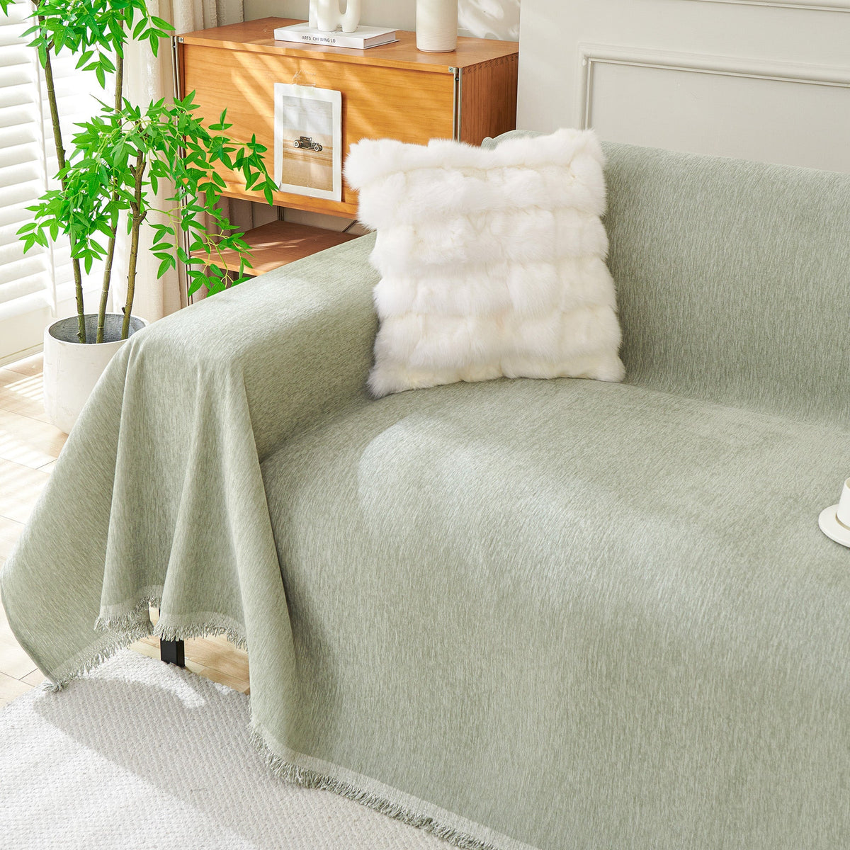 Sage green woven cover over a sofa arm
