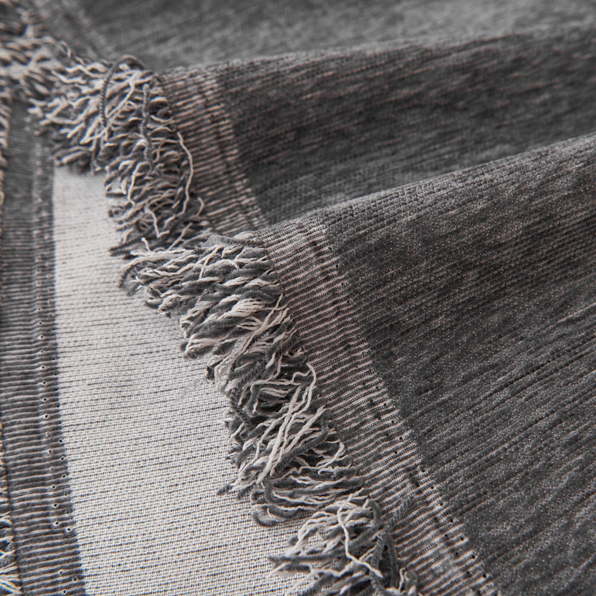 Close view of the dark gray fringed edge