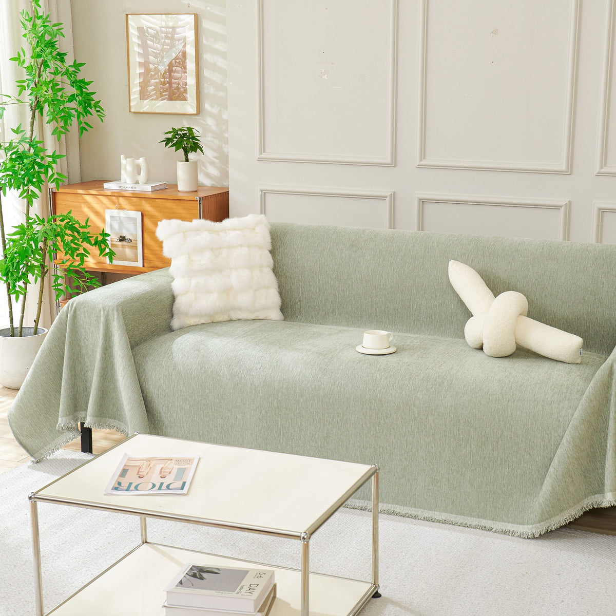 Sage green woven sofa cover over a sofa