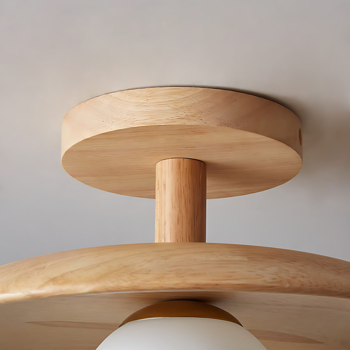 Close view of the wood plate, stem and disc of the Gerda semi flush ceiling light