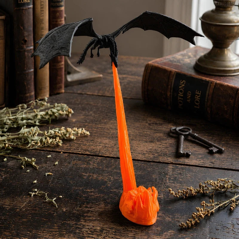 Holte dragon night light on a wood table with dried herbs
