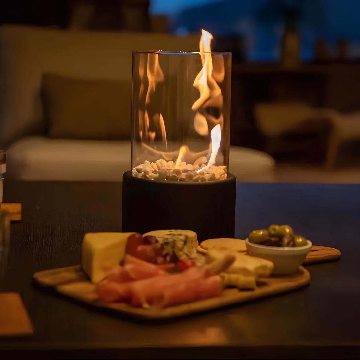 Horten fire lamp beside a cheese board on a patio table