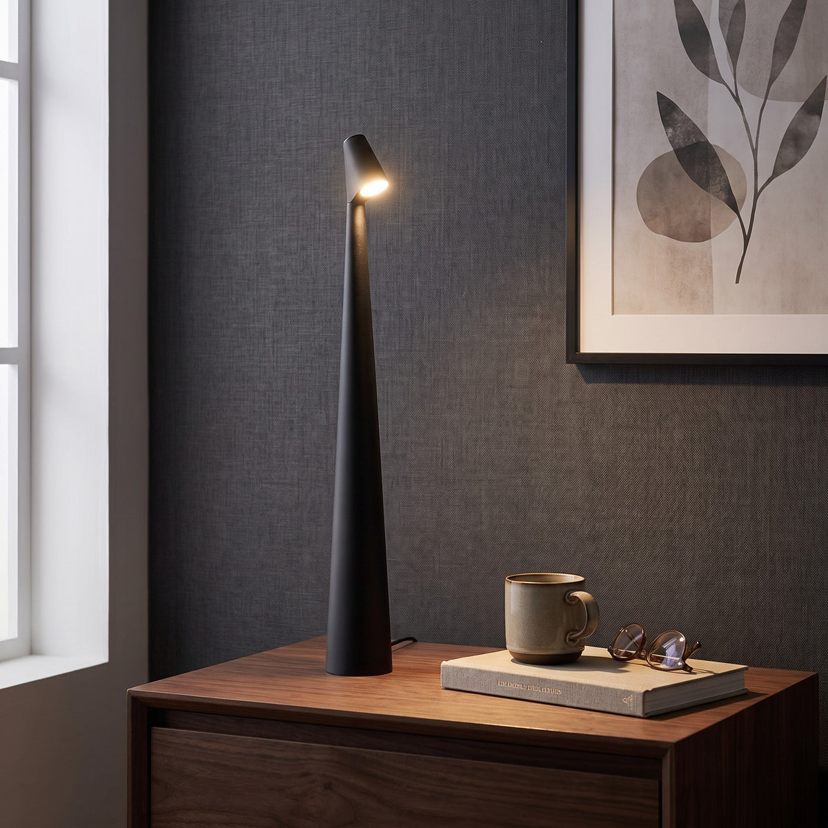 Iben table lamp in Black on a nightstand beside a window