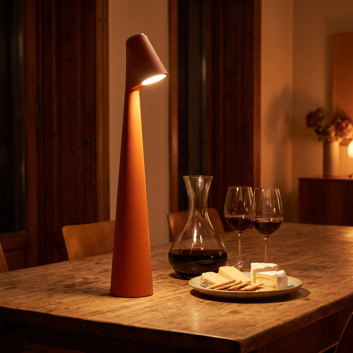 Iben table lamp in brown on a dining table in the evening