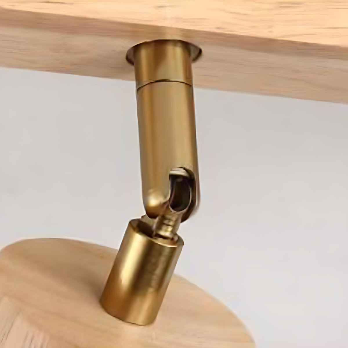 Close view of the brass swivel joint on the Iida spotlight