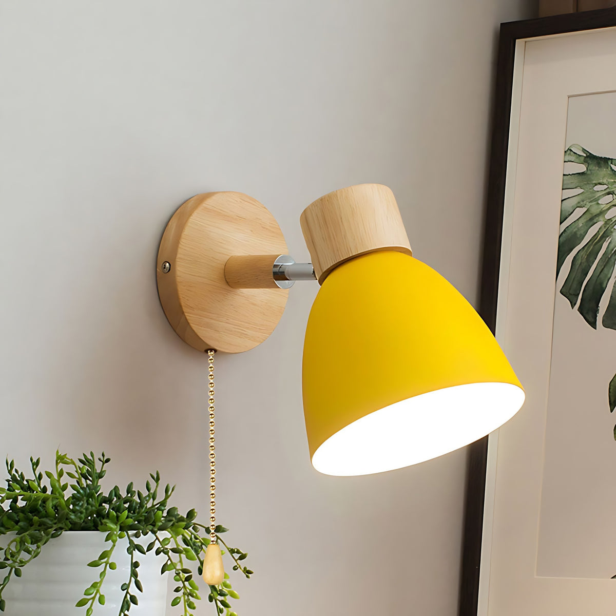 Yellow Juni wall sconce with a pull chain