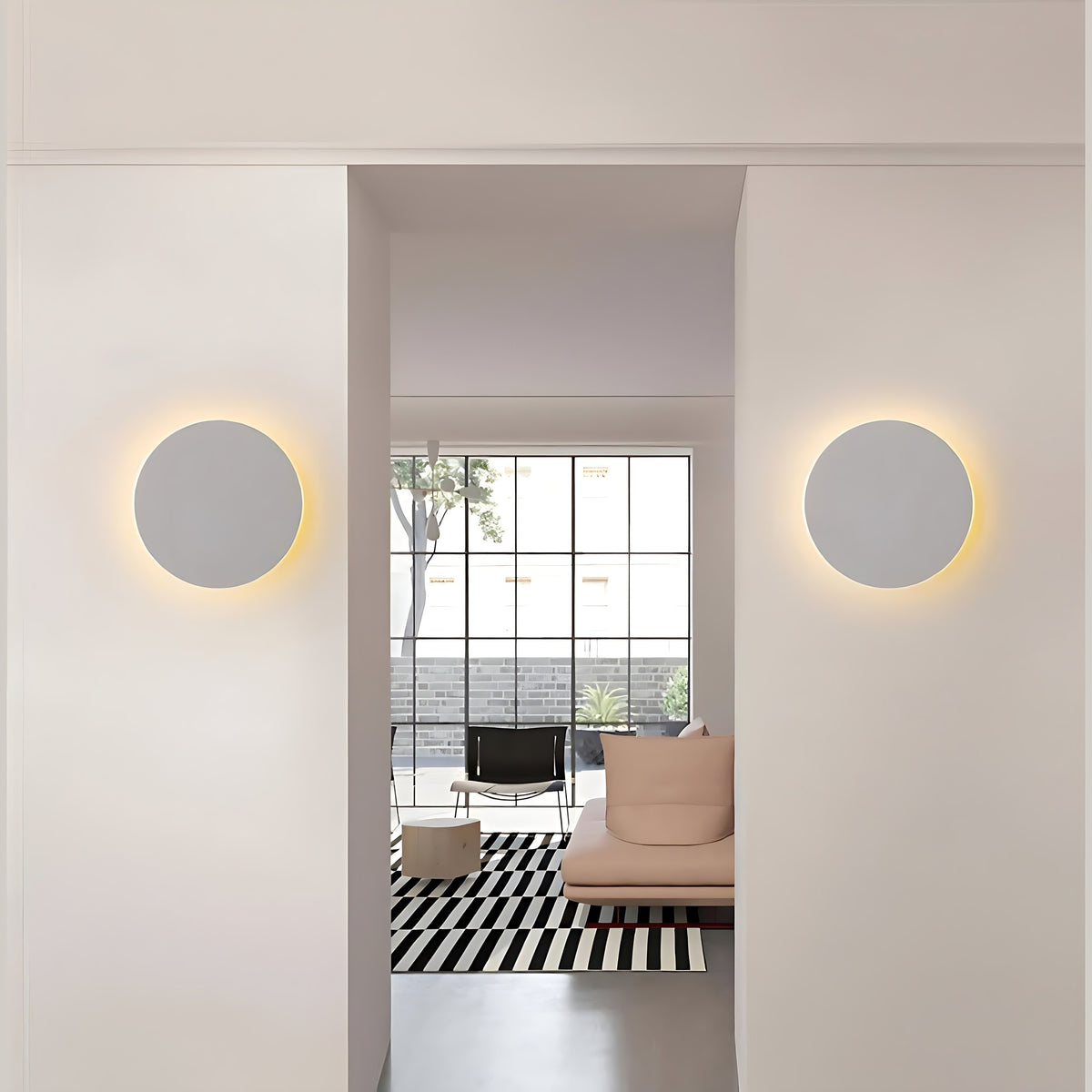 Two white Kaja LED wall sconces either side of a doorway