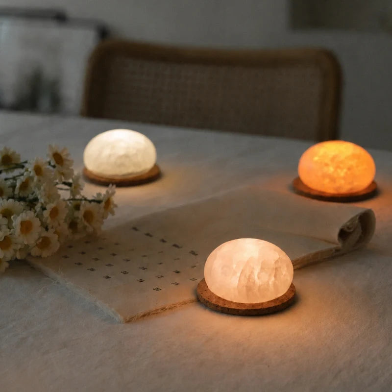 Three Kvist dome lights in Alabaster on a table runner