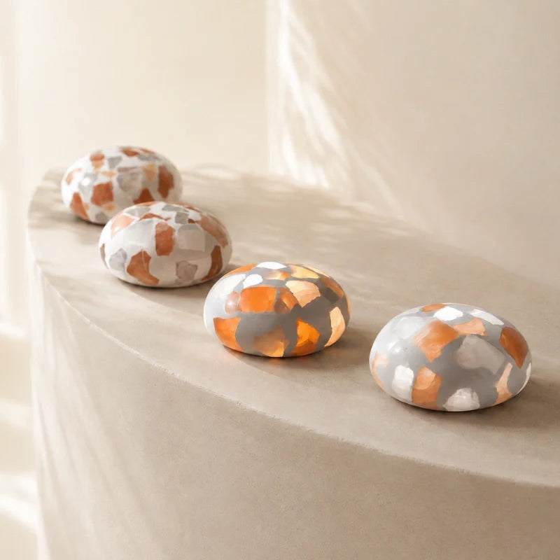 Four Kvist dome lights in Terrazzo along a stone ledge
