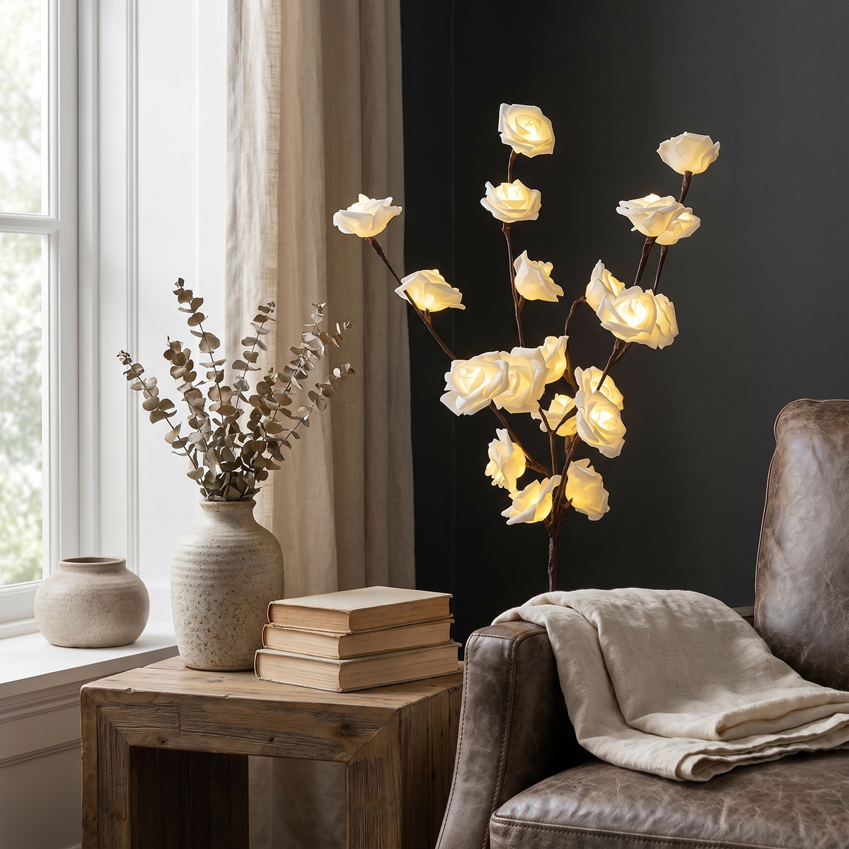 Close view of lighted white rose branches beside an armchair