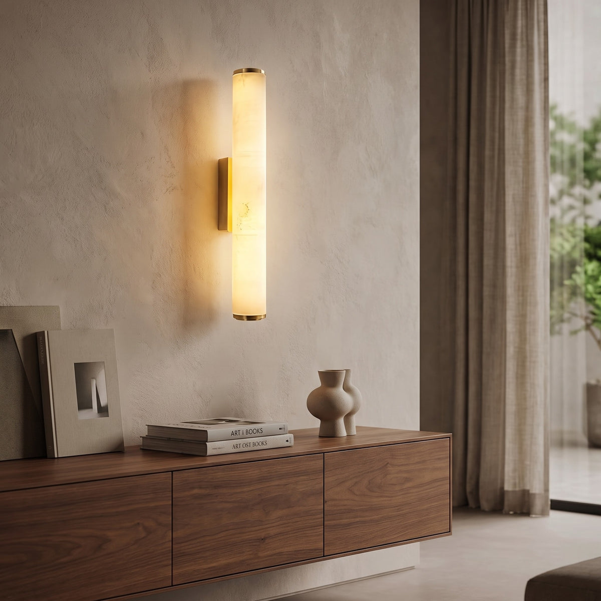 Gold Linn wall sconce lit over a walnut console