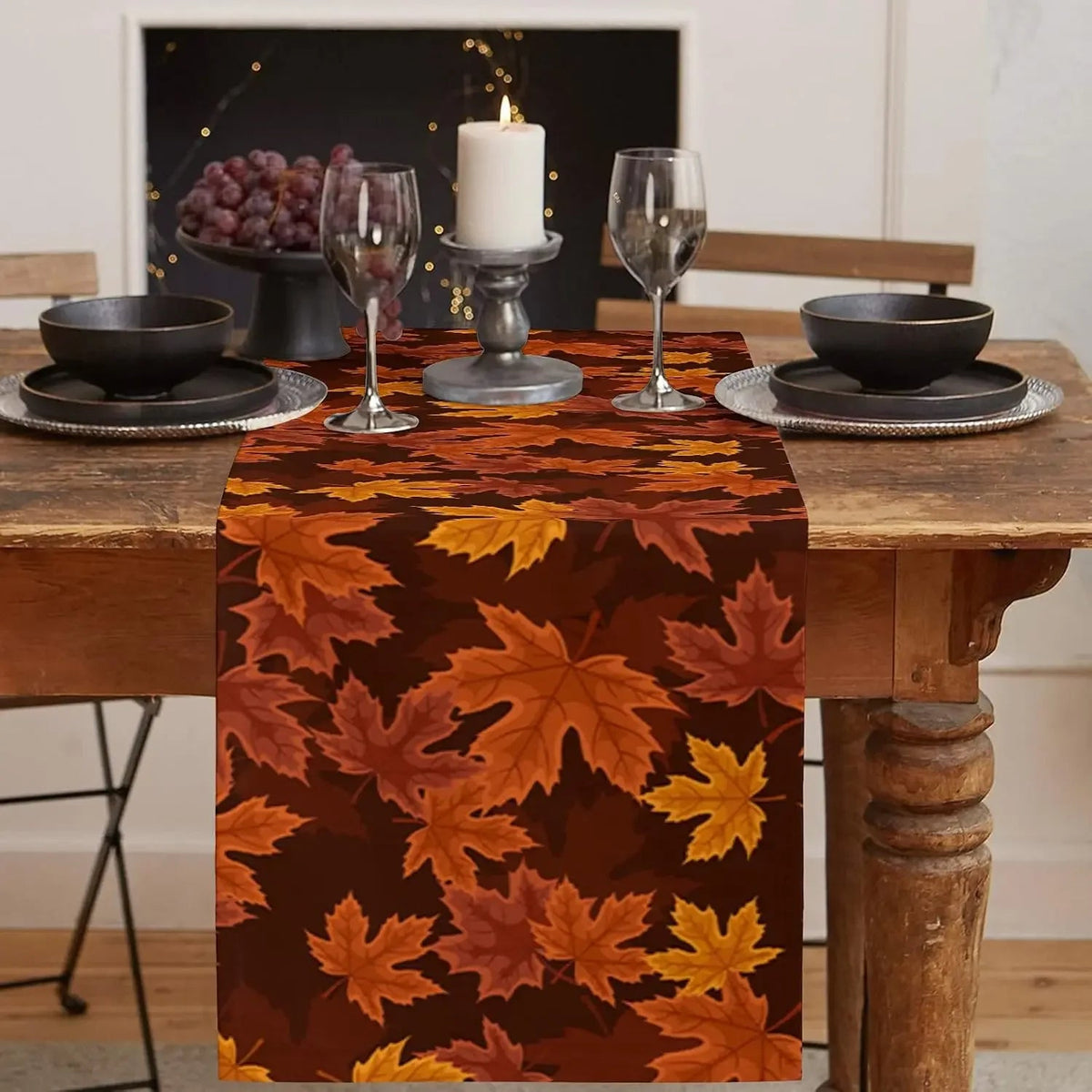 Maple leaf print runner on a wood table with a candle and glasses