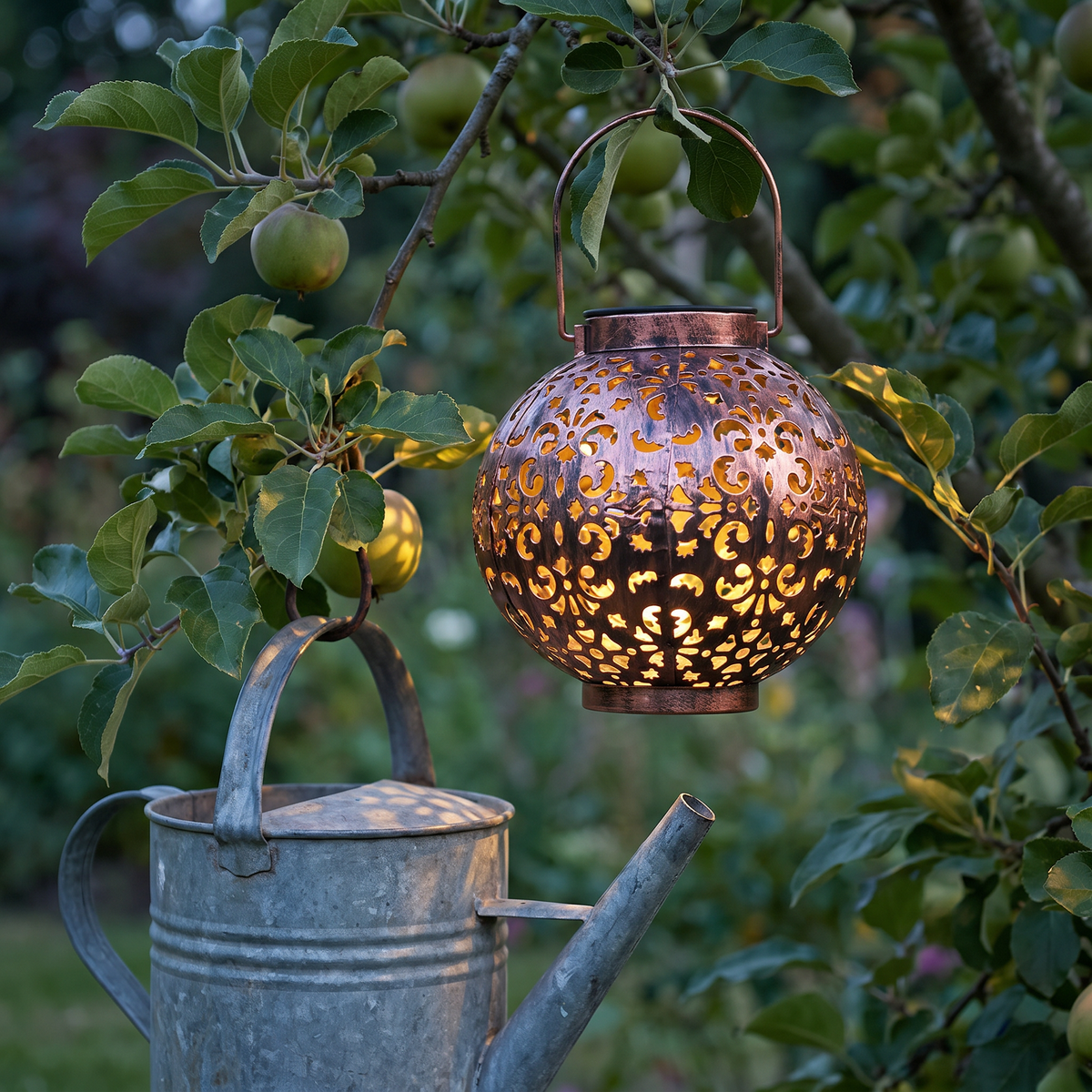 Mette solar lantern hanging from an apple tree at blue hour