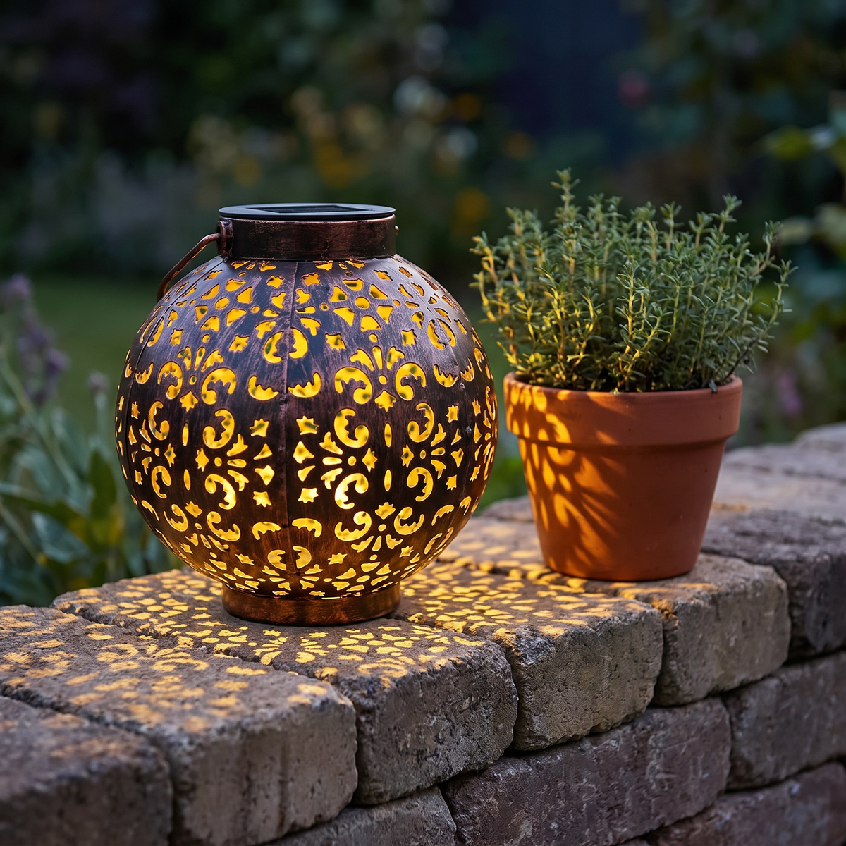 Mette solar lantern on a garden wall beside a pot of thyme