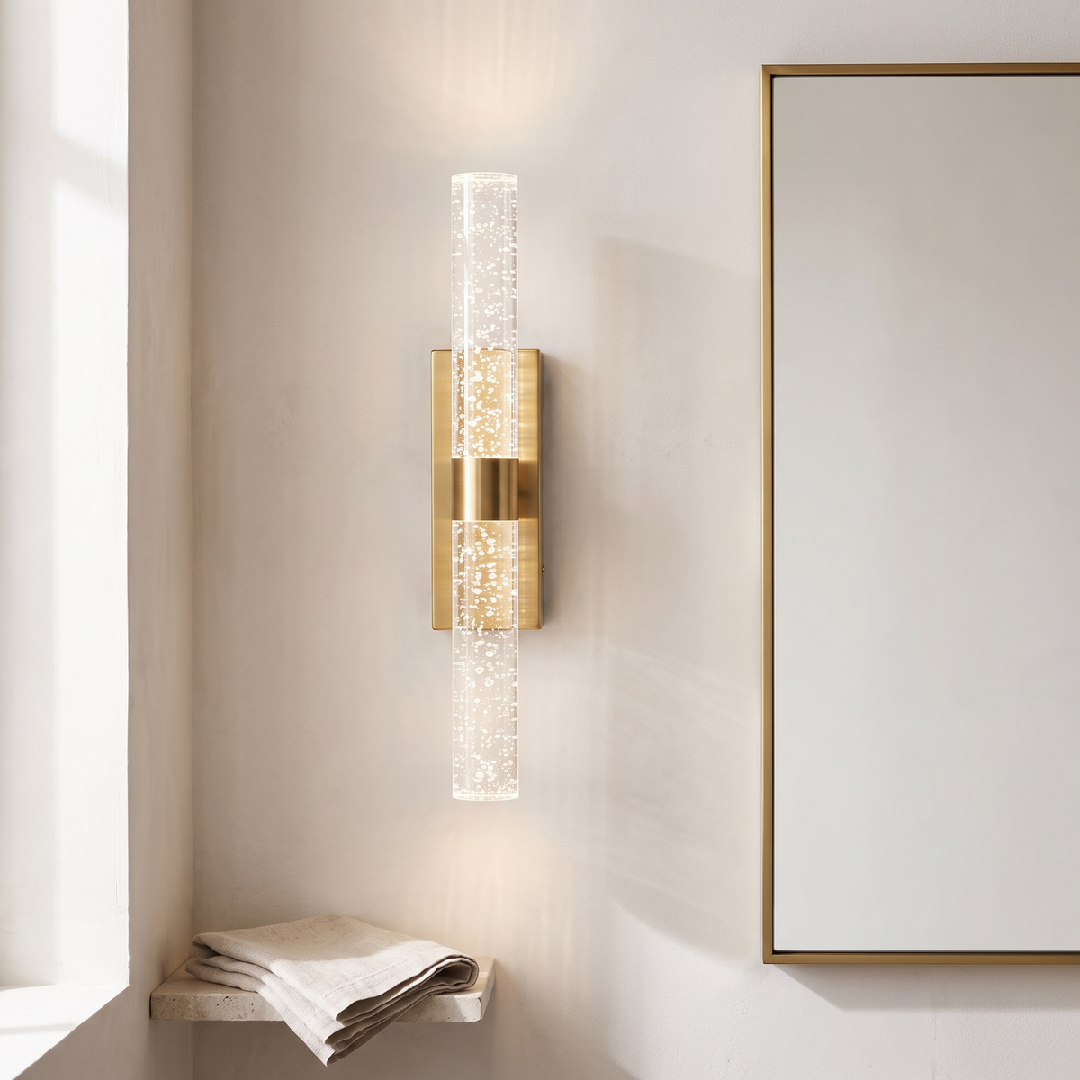 Namsos bubble crystal wall light glowing beside a mirror