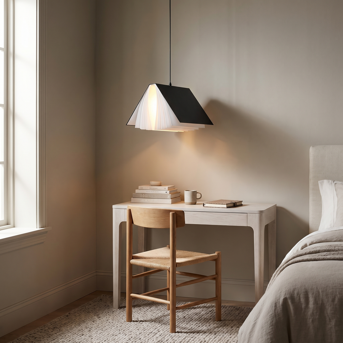 Black book pendant light above a white desk by a bedroom window