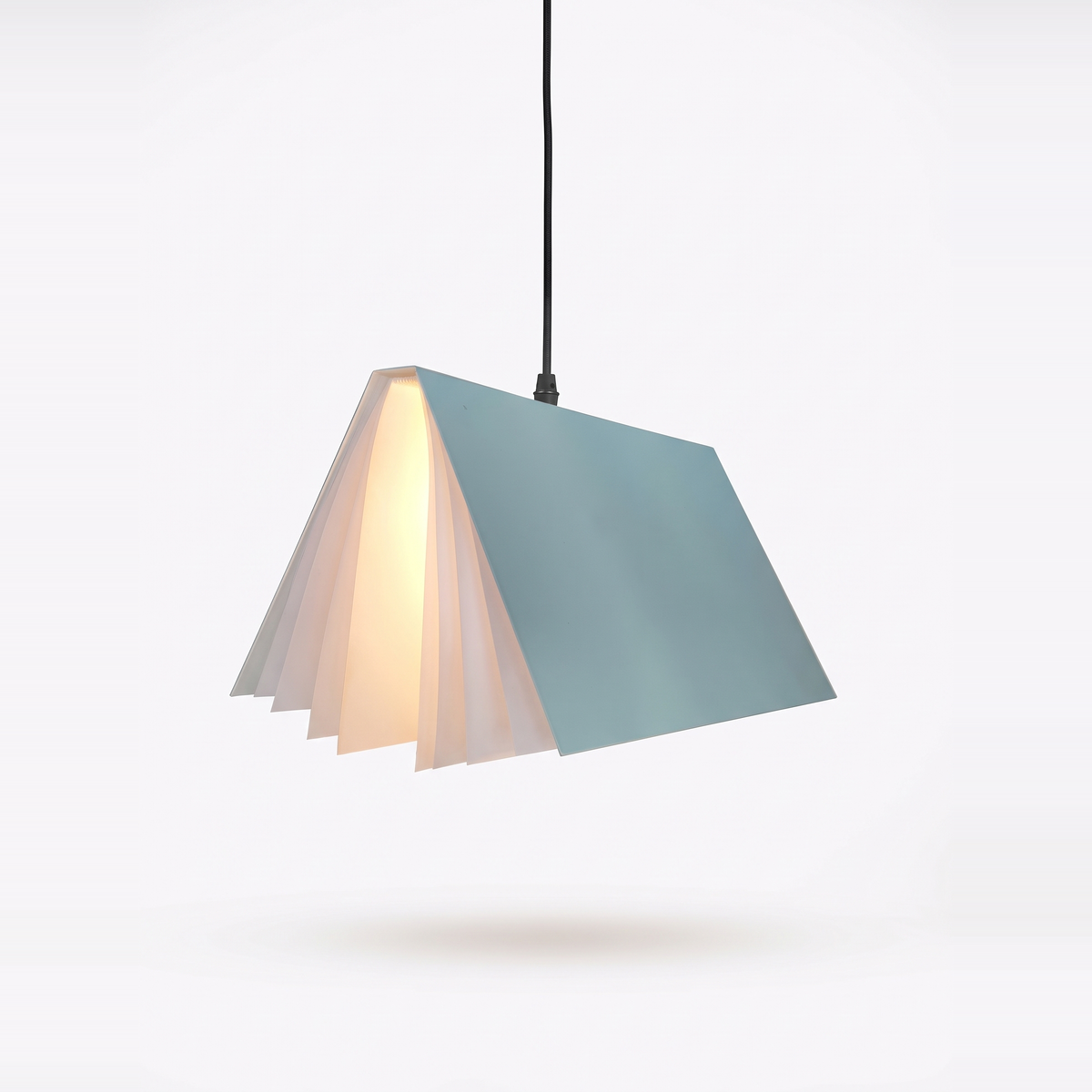 Blue book pendant light lit on a white background