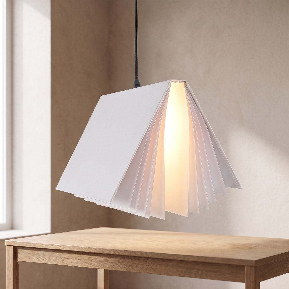 Nesna book pendant light in white, lit above an oak desk