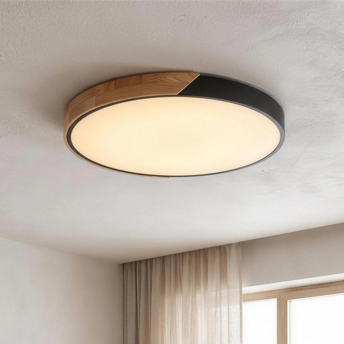 Oda LED ceiling light, black rim with a wood segment, lit on a plaster ceiling
