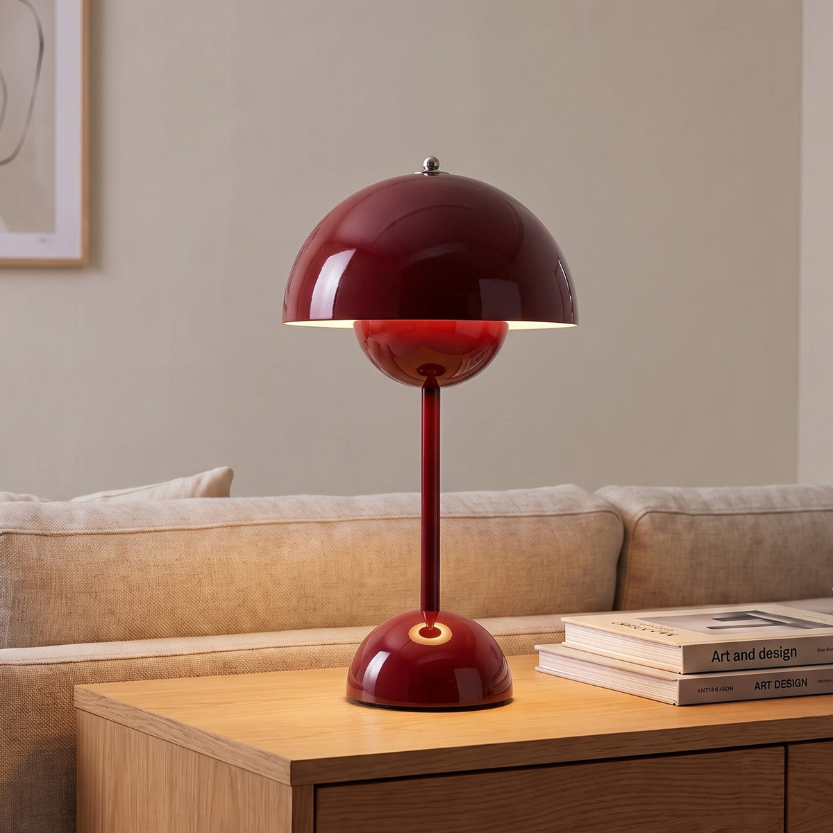 Oona table lamp in Deep Red on a sideboard beside a sofa