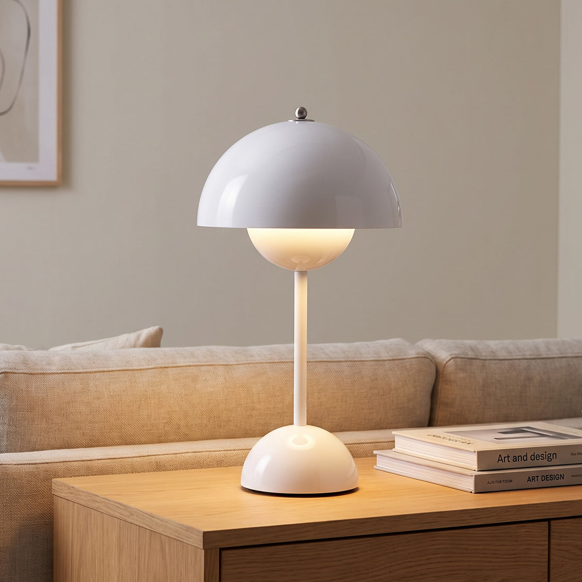 Oona table lamp in White on a sideboard beside a sofa
