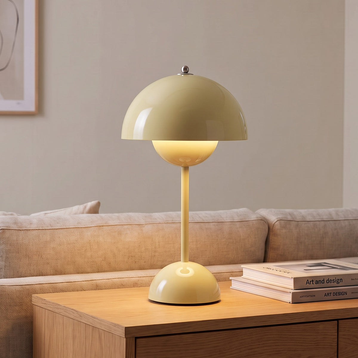 Oona table lamp in Light Yellow on a sideboard beside a sofa