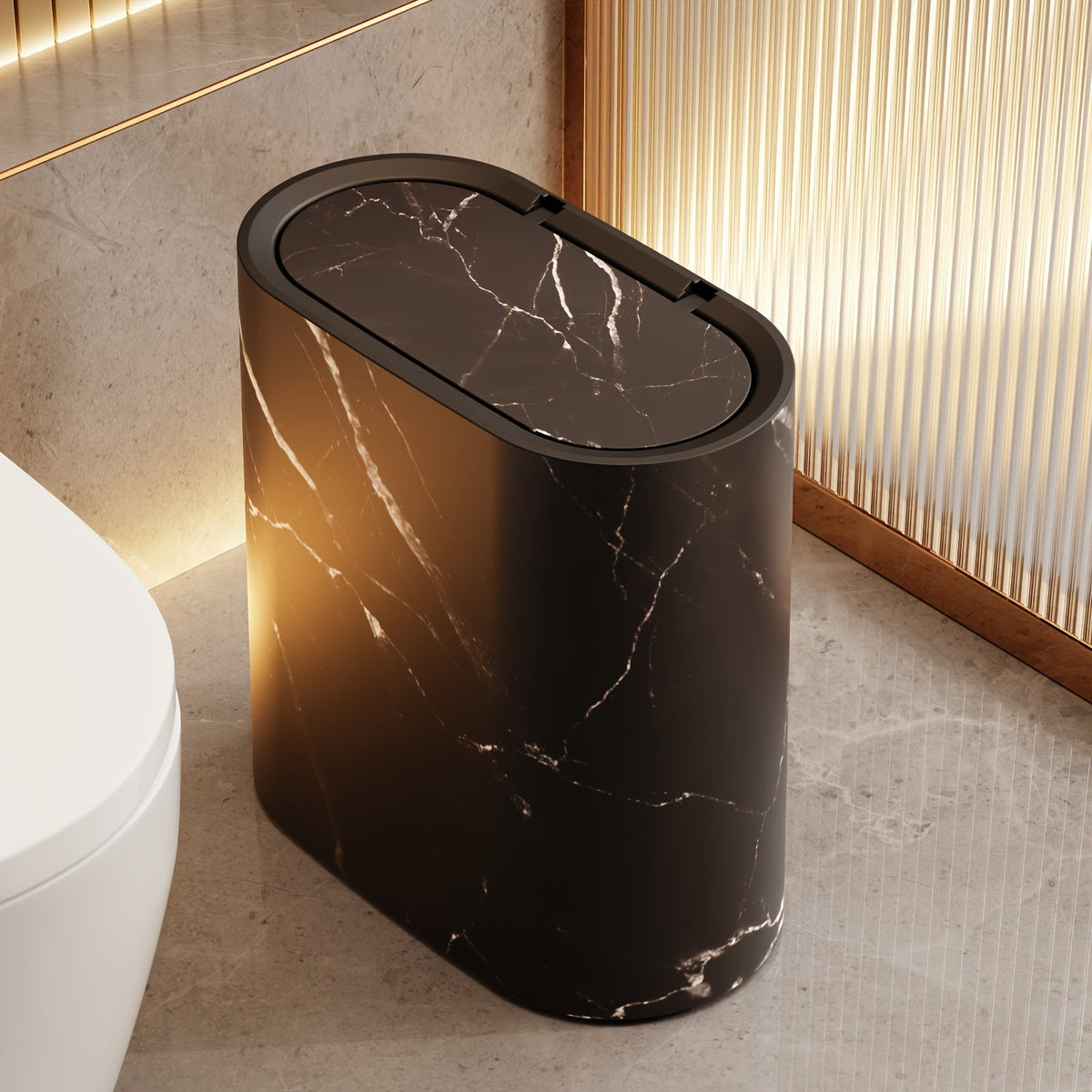 Black marble oval waste bin beside a toilet