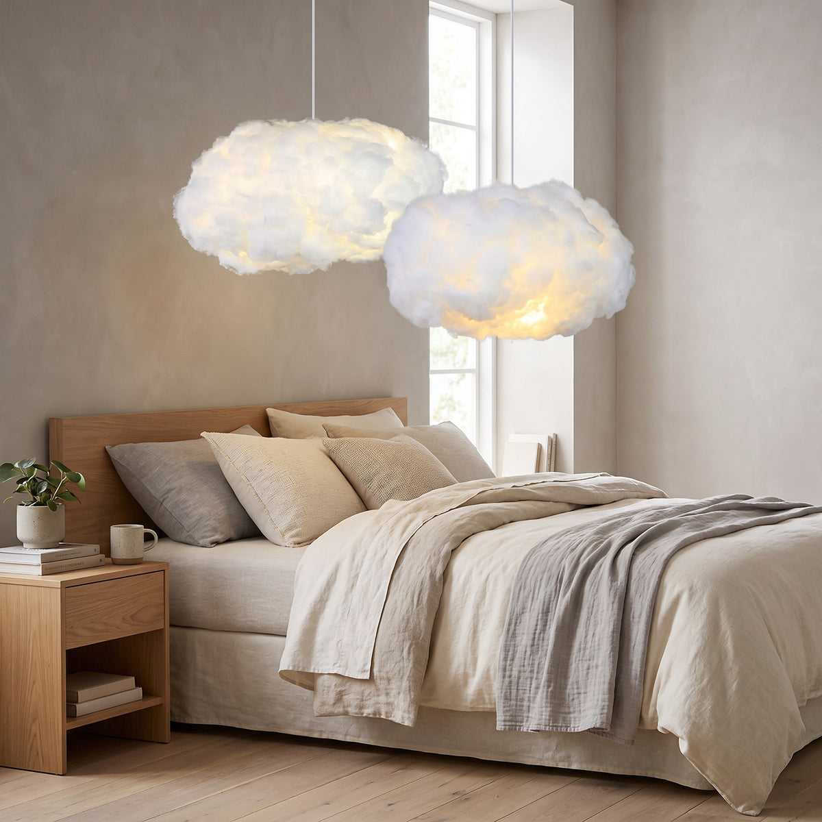 Two Petra cloud pendant lights glowing over a bed
