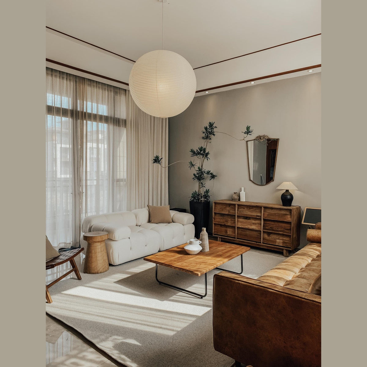 Pia pendant light, white washi paper globe lit in a living room