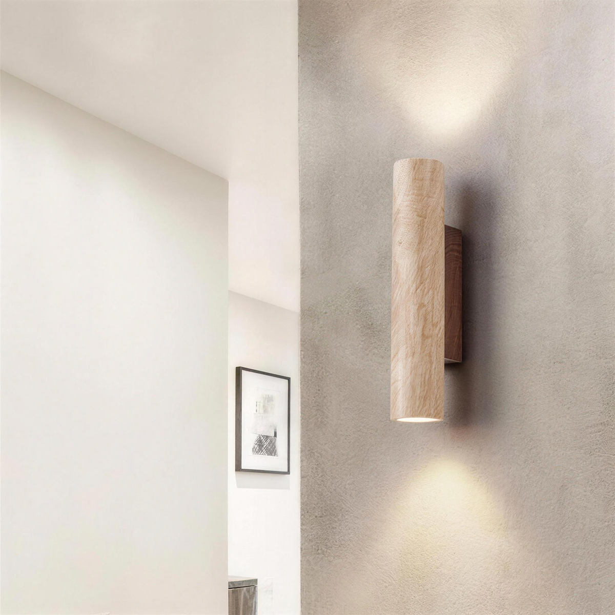 Rakel wall sconce seen from the side on a concrete wall, lit up and down