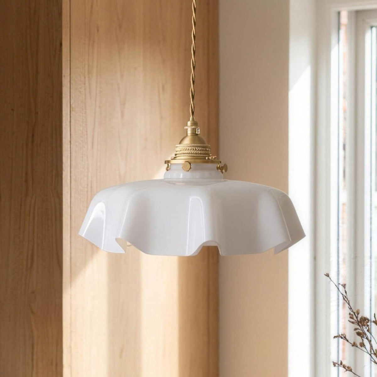 Ronja pendant light with a white scalloped glass shade over a kitchen table